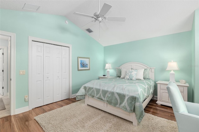 1521 Southport St, The Villages, FL 32162 - bedroom with vaulted ceiling, wood finished floors, a closet, a ceiling fan, and baseboards