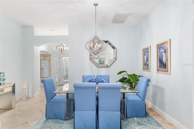 1521 Southport St, The Villages, FL 32162 - tiled dining room with a chandelier, arched walkways, and baseboards