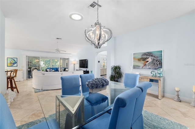 1521 Southport St, The Villages, FL 32162 - dining room featuring arched walkways, ceiling fan, a chandelier, light tile patterned floors, and baseboards