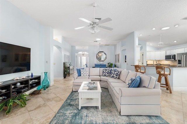 1521 Southport St, The Villages, FL 32162 - living area featuring ceiling fan, arched walkways, light tile patterned flooring, baseboards, and recessed lighting