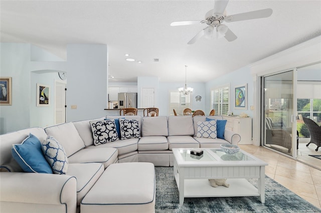 1521 Southport St, The Villages, FL 32162 - living room with ceiling fan, a chandelier, light tile patterned flooring, arched walkways, and a textured ceiling
