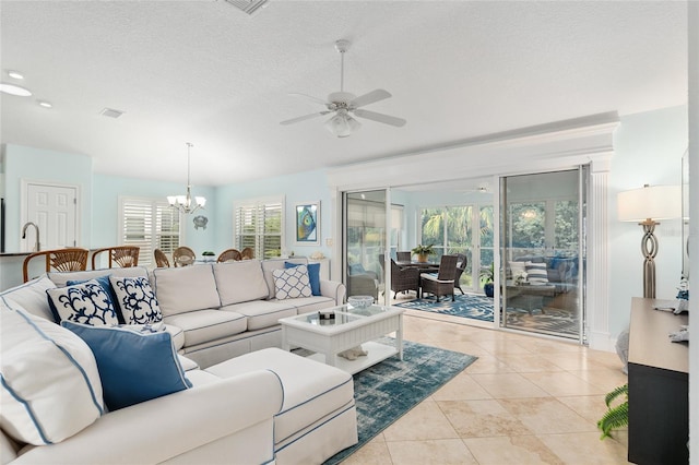 1521 Southport St, The Villages, FL 32162 - living area with a ceiling fan, a chandelier, a textured ceiling, light tile patterned floors, and recessed lighting