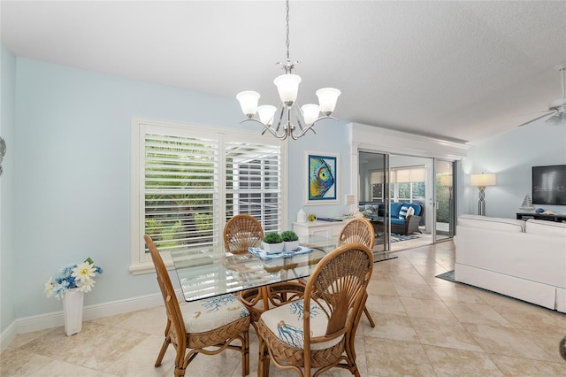 1521 Southport St, The Villages, FL 32162 - dining space featuring a chandelier, light tile patterned floors, a textured ceiling, a ceiling fan, and baseboards