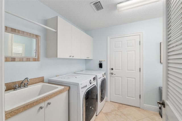 1521 Southport St, The Villages, FL 32162 - laundry room with cabinet space, separate washer and dryer, light tile patterned floors, a textured ceiling, and baseboards
