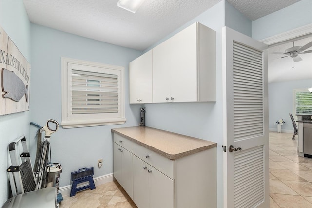 1521 Southport St, The Villages, FL 32162 - laundry room featuring ceiling fan, light tile patterned flooring, a textured ceiling, and baseboards