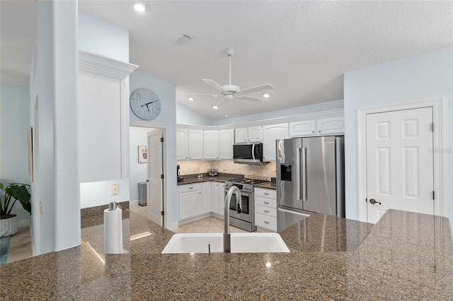 1521 Southport St, The Villages, FL 32162 - kitchen featuring stainless steel appliances, a ceiling fan, backsplash, white cabinetry, and lofted ceiling