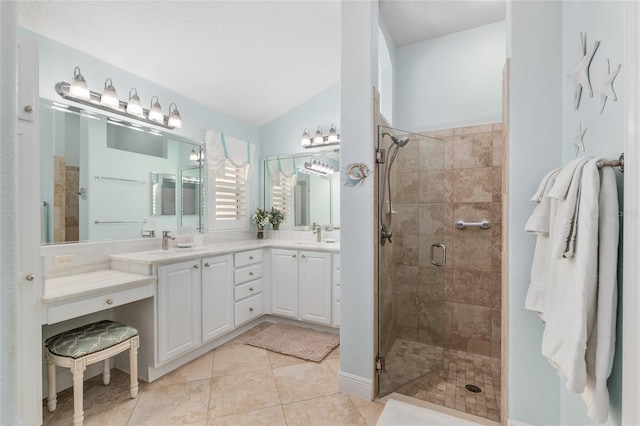 1521 Southport St, The Villages, FL 32162 - bathroom with a shower stall, double vanity, tile patterned floors, and vaulted ceiling