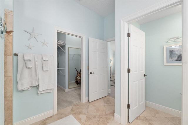 1521 Southport St, The Villages, FL 32162 - bathroom with a walk in closet, tile patterned flooring, and baseboards