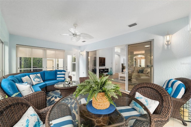 1521 Southport St, The Villages, FL 32162 - tiled living room with a ceiling fan, arched walkways, and a textured ceiling