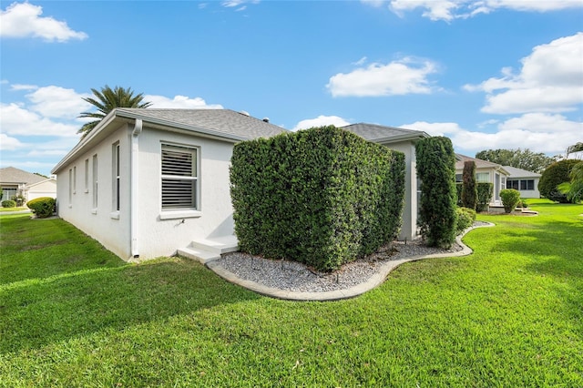 1521 Southport St, The Villages, FL 32162 - view of side of property with stucco siding and a lawn