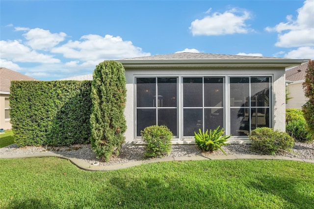 1521 Southport St, The Villages, FL 32162 - rear view of property with a lawn, stucco siding, and a sunroom