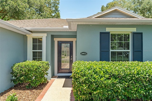 26822 Bull Run, Leesburg, FL 34748 - entrance to property with stucco siding and a shingled roof