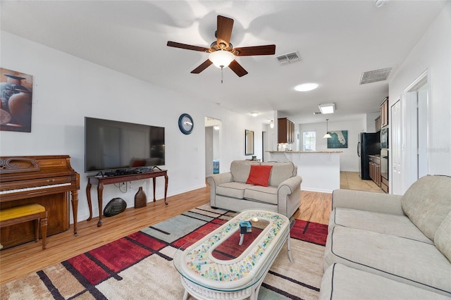 26822 Bull Run, Leesburg, FL 34748 - living area featuring ceiling fan, light wood finished floors, and baseboards