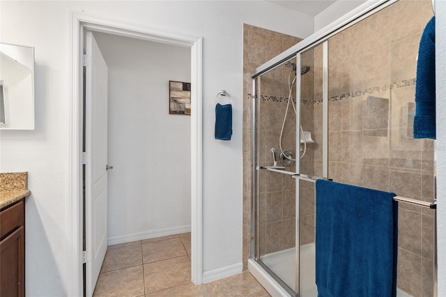 26822 Bull Run, Leesburg, FL 34748 - full bathroom featuring vanity, a shower stall, baseboards, and tile patterned floors