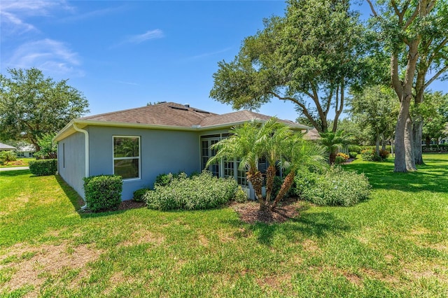 26822 Bull Run, Leesburg, FL 34748 - view of side of property featuring stucco siding and a yard
