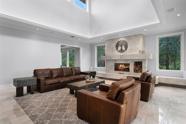 10122 Royal Island Ct, Orlando, FL 32836 - living area with a high end fireplace, recessed lighting, baseboards, a high ceiling, and ornamental molding