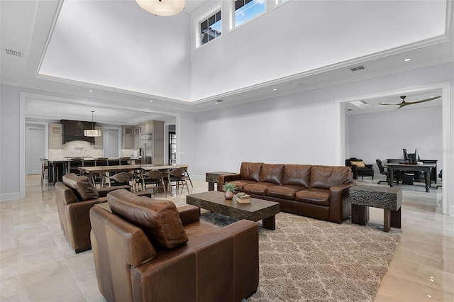 10122 Royal Island Ct, Orlando, FL 32836 - living room featuring a ceiling fan, a towering ceiling, baseboards, and recessed lighting