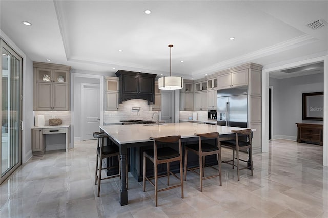 10122 Royal Island Ct, Orlando, FL 32836 - kitchen with stainless steel built in refrigerator, decorative backsplash, glass insert cabinets, light countertops, and a large island