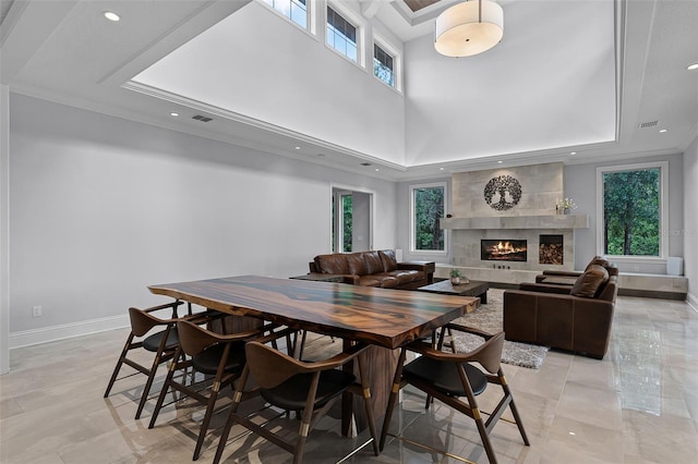 10122 Royal Island Ct, Orlando, FL 32836 - dining room with recessed lighting, baseboards, a raised ceiling, a fireplace, and crown molding