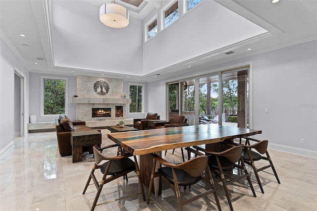 10122 Royal Island Ct, Orlando, FL 32836 - dining area with baseboards, a fireplace, recessed lighting, a raised ceiling, and crown molding