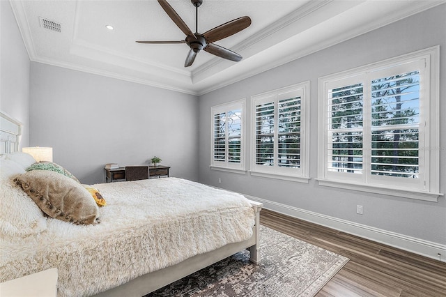 10122 Royal Island Ct, Orlando, FL 32836 - bedroom with a raised ceiling, multiple windows, wood finished floors, baseboards, and ornamental molding