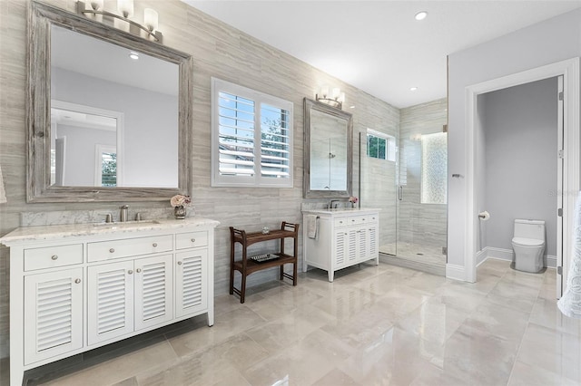 10122 Royal Island Ct, Orlando, FL 32836 - full bathroom with a shower stall, tile walls, two vanities, toilet, and recessed lighting