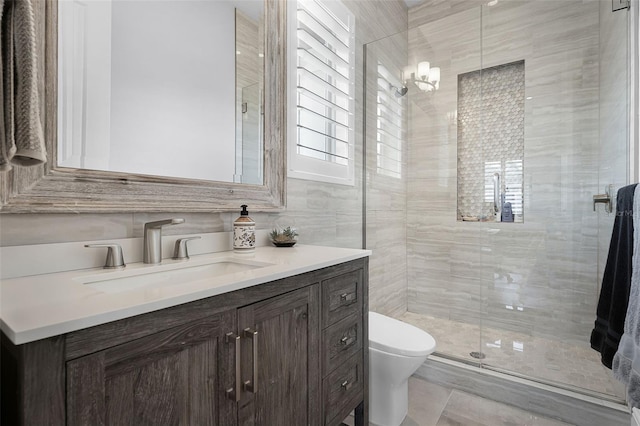 10122 Royal Island Ct, Orlando, FL 32836 - bathroom featuring a shower stall, toilet, vanity, and tile walls