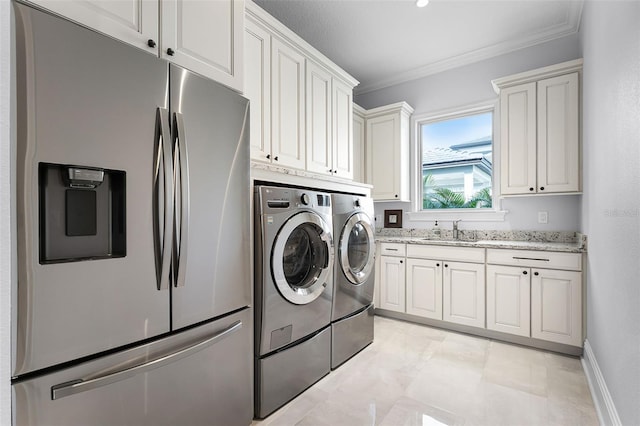 10122 Royal Island Ct, Orlando, FL 32836 - washroom with washer and clothes dryer, ornamental molding, cabinet space, and baseboards