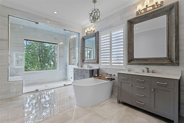 10122 Royal Island Ct, Orlando, FL 32836 - full bathroom featuring crown molding, a chandelier, a tile shower, two vanities, and a freestanding tub