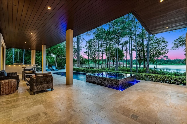 10122 Royal Island Ct, Orlando, FL 32836 - patio terrace at dusk with an outdoor pool, an outdoor hangout area, and a water view