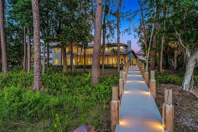 10122 Royal Island Ct, Orlando, FL 32836 - back of house at dusk featuring a chimney