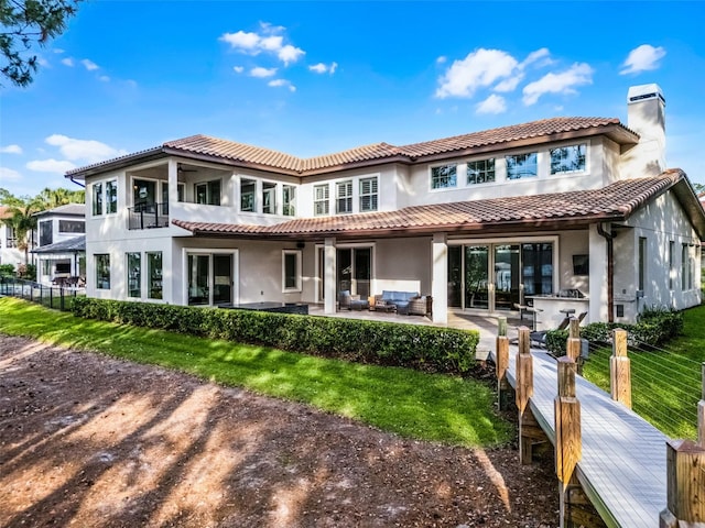 10122 Royal Island Ct, Orlando, FL 32836 - back of property with an outdoor hangout area, stucco siding, a chimney, a patio, and a tile roof