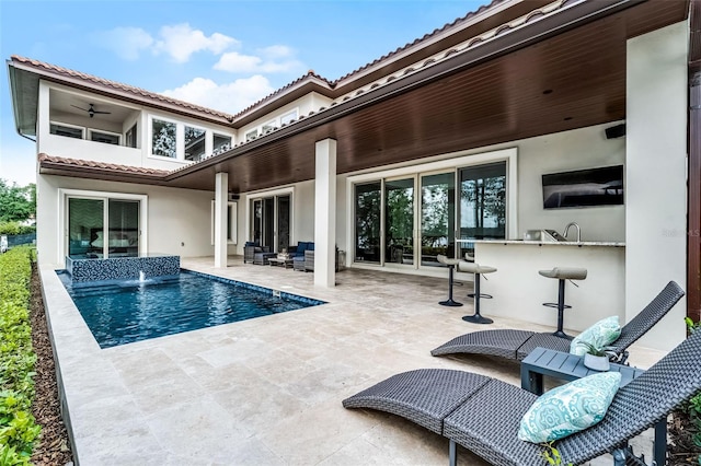 10122 Royal Island Ct, Orlando, FL 32836 - back of house with stucco siding, a patio, a tile roof, an outdoor pool, and an outdoor living space