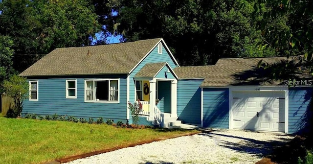 1225 E 1st Ave, Mount Dora, FL 32757 - view of front of property with gravel driveway, an attached garage, roof with shingles, and a front lawn