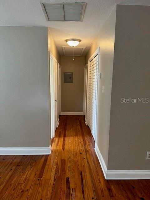 1225 E 1st Ave, Mount Dora, FL 32757 - hall with attic access, baseboards, and wood finished floors