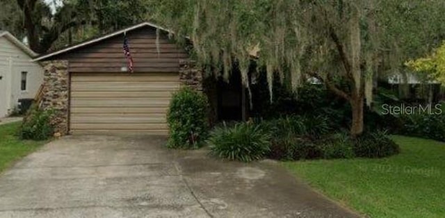 111 Frosti Way, Eustis, FL 32726 - view of front of home featuring a detached garage, an outbuilding, and driveway