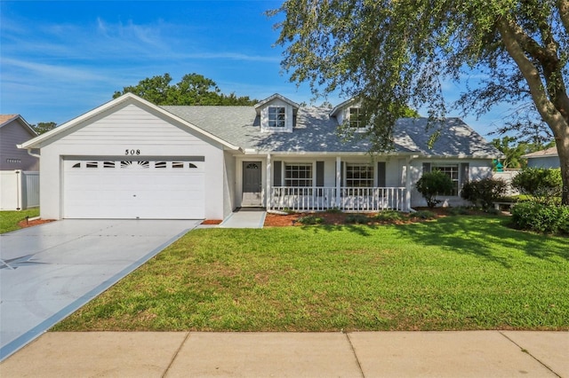 508 Woodview Dr, Tavares, FL 32778 - view of front facade featuring covered porch, a garage, a front yard, and driveway