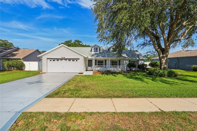 508 Woodview Dr, Tavares, FL 32778 - view of front of house with covered porch, an attached garage, and driveway