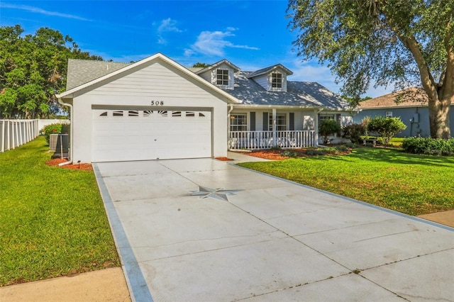 508 Woodview Dr, Tavares, FL 32778 - view of front of property featuring an attached garage, a porch, driveway, stucco siding, and a shingled roof