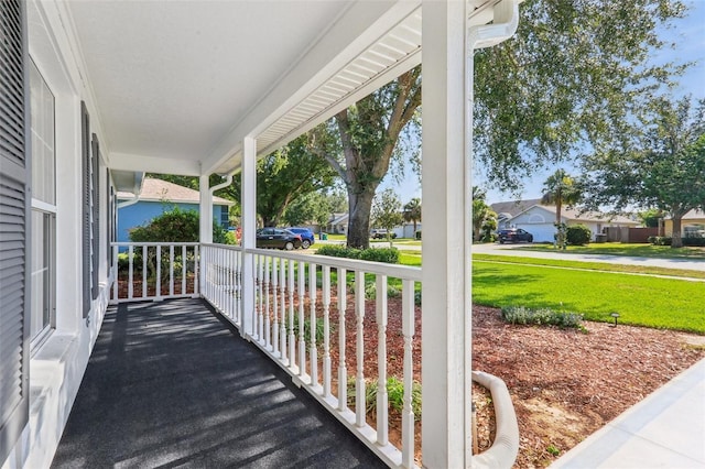 508 Woodview Dr, Tavares, FL 32778 - wooden porch featuring a residential view and a lawn