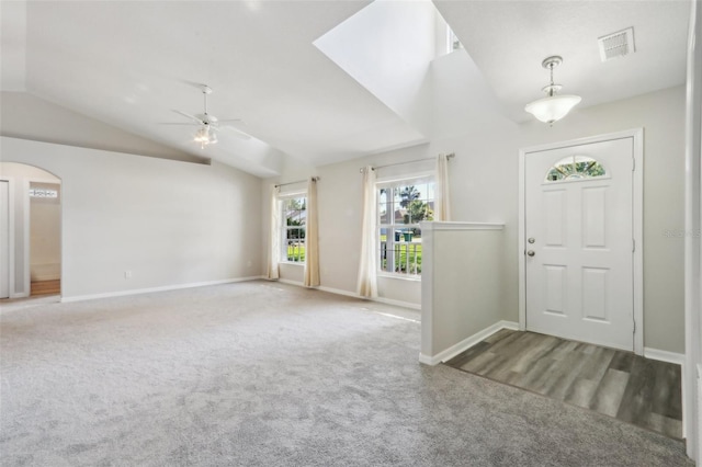 508 Woodview Dr, Tavares, FL 32778 - entryway with a ceiling fan, lofted ceiling, carpet flooring, baseboards, and arched walkways