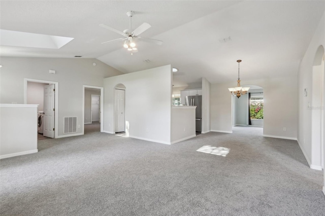 508 Woodview Dr, Tavares, FL 32778 - unfurnished living room featuring lofted ceiling, a ceiling fan, arched walkways, carpet, and baseboards