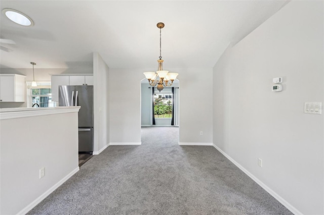 508 Woodview Dr, Tavares, FL 32778 - spare room with a chandelier, dark colored carpet, and baseboards