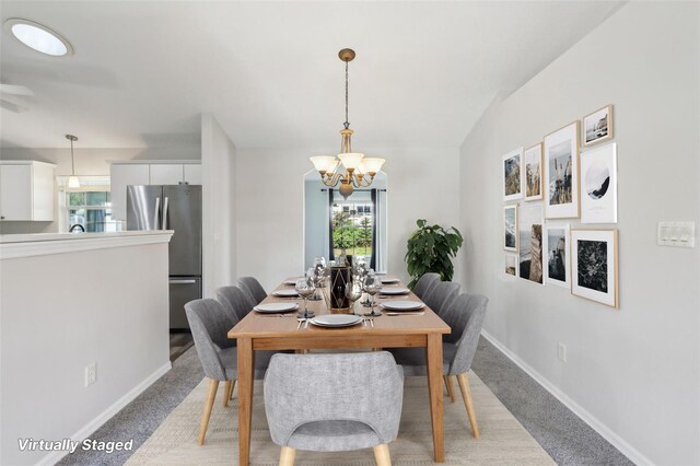 508 Woodview Dr, Tavares, FL 32778 - dining room featuring a chandelier, light colored carpet, plenty of natural light, and baseboards