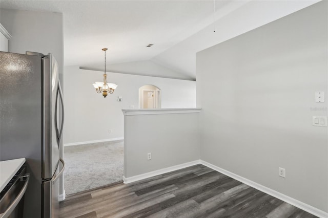 508 Woodview Dr, Tavares, FL 32778 - kitchen with stainless steel appliances, dark wood-type flooring, a chandelier, vaulted ceiling, and baseboards