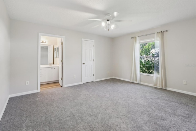 508 Woodview Dr, Tavares, FL 32778 - unfurnished bedroom featuring light carpet, baseboards, and connected bathroom