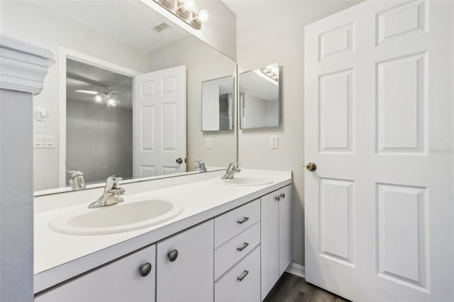508 Woodview Dr, Tavares, FL 32778 - bathroom featuring double vanity, a ceiling fan, and wood finished floors