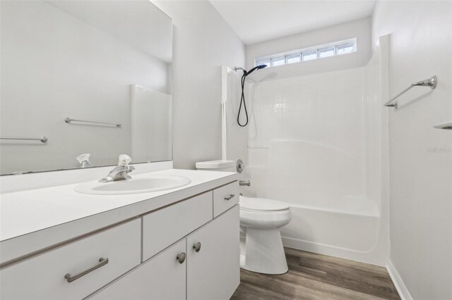 508 Woodview Dr, Tavares, FL 32778 - full bath with vanity, shower / tub combination, wood finished floors, and toilet