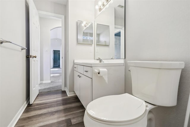 508 Woodview Dr, Tavares, FL 32778 - bathroom featuring vanity, wood finished floors, toilet, and baseboards