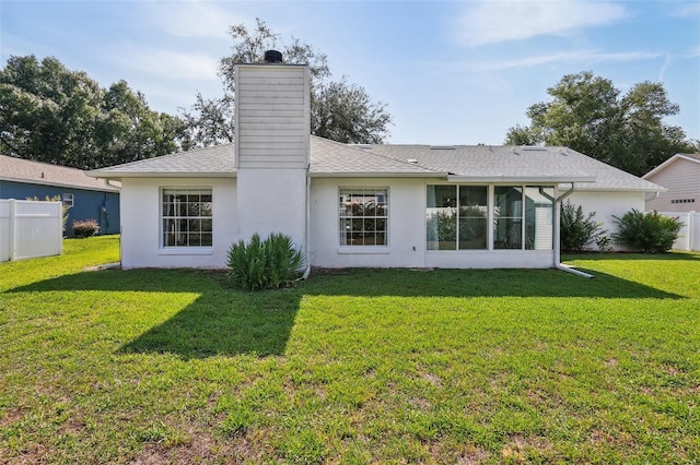 508 Woodview Dr, Tavares, FL 32778 - back of property with a chimney, stucco siding, a sunroom, and roof with shingles